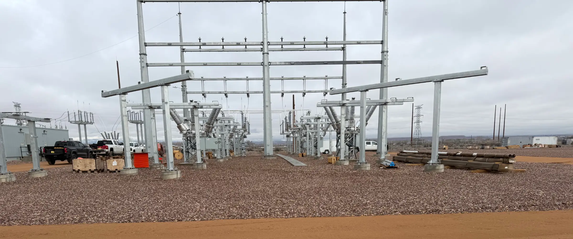 Substation under construction, with new steel structures and equipment on a gravel yard