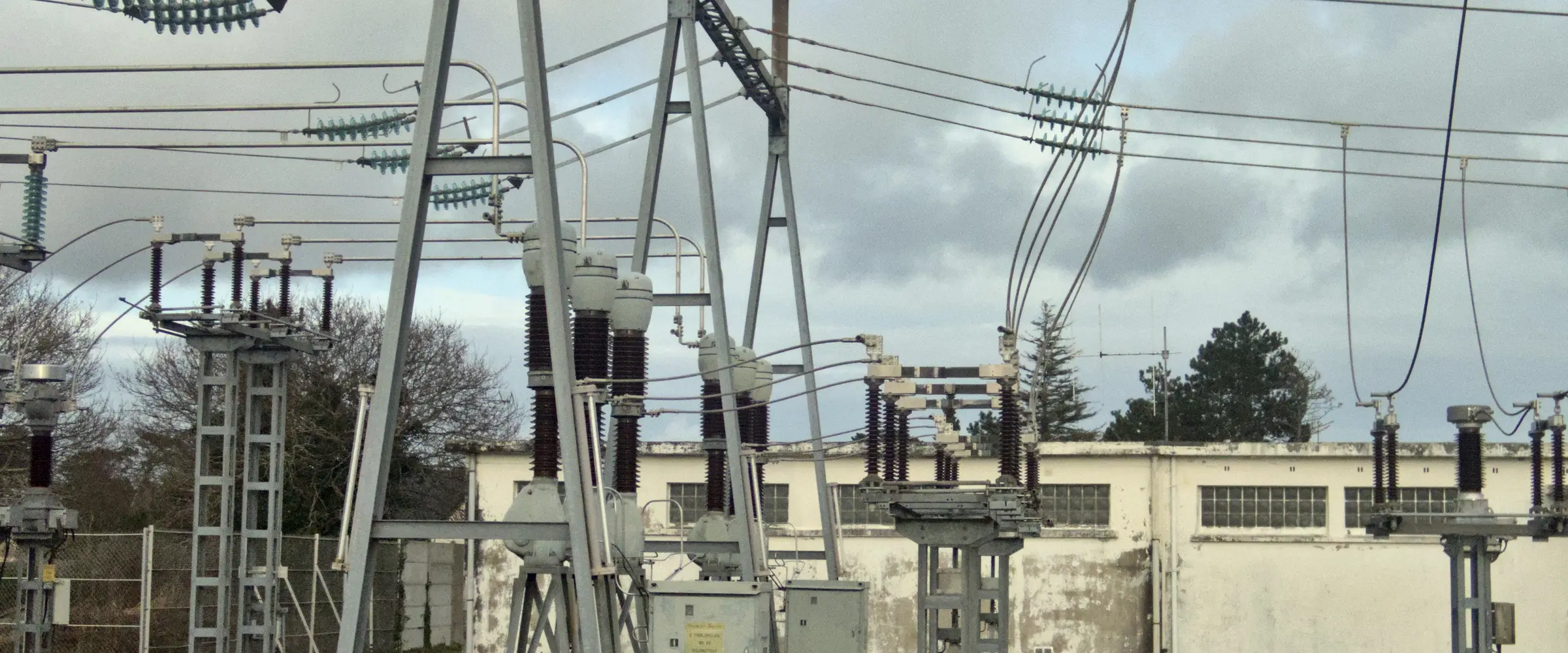 Substation disconnect switches and steel gantry against the sky
