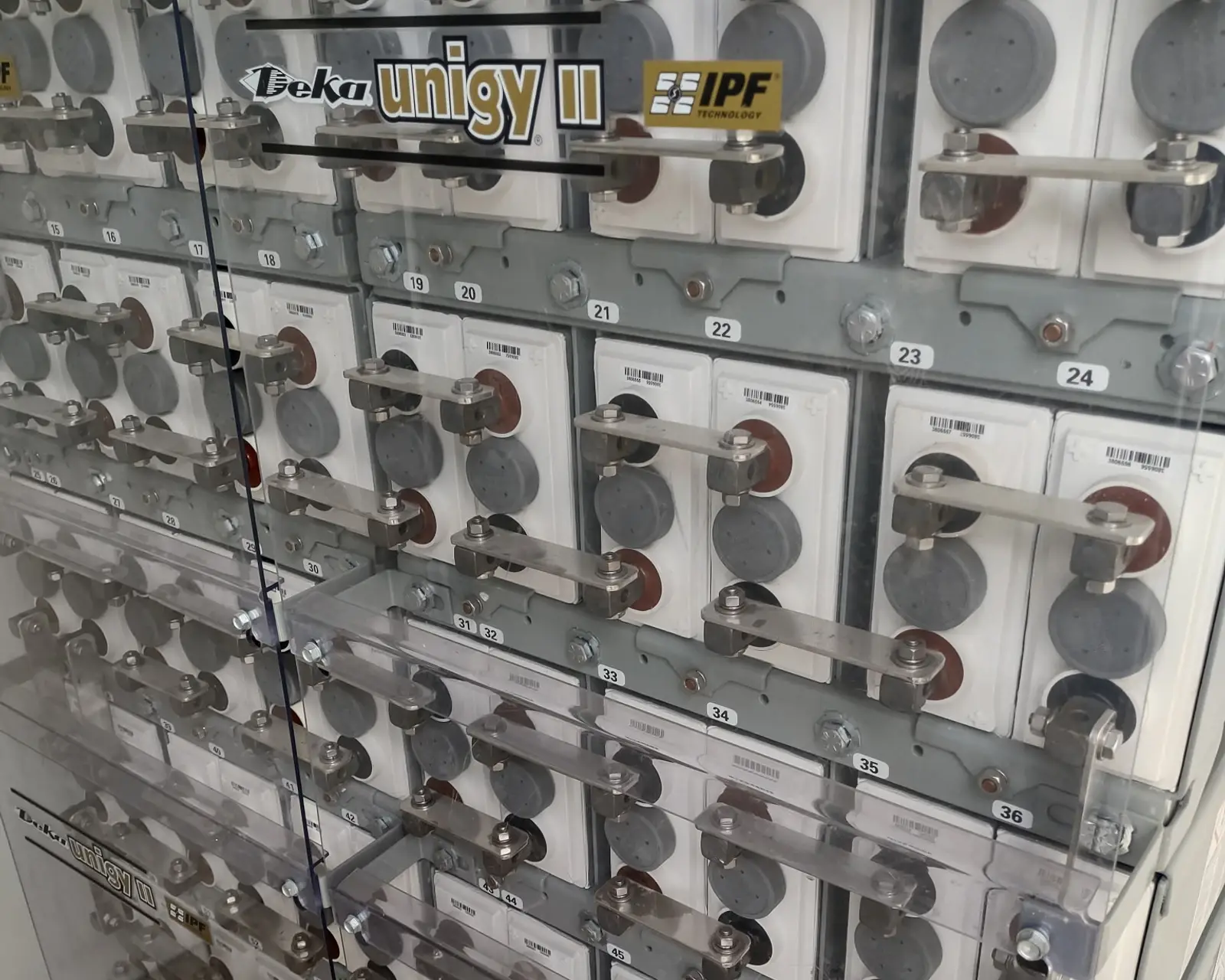 Close-up of a substation battery bank with numbered cells and connecting straps