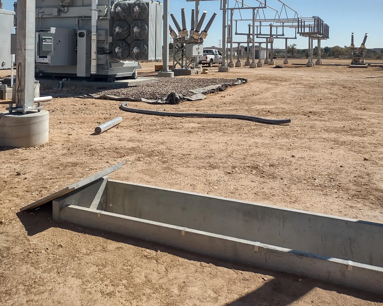 New power transformer with cooling fans, with breakers and bus structures behind it